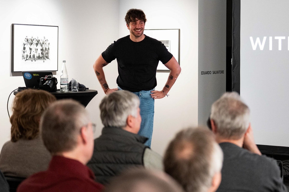 Laurin Strele speaking to an audience during the Worlds Apart exhibition programme at Artdepot Innsbruck.