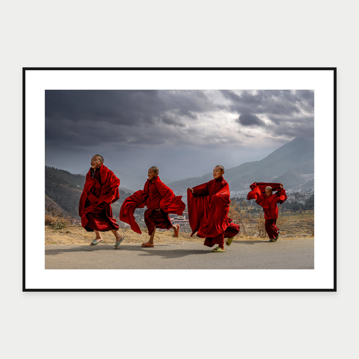 Black-framed display mockup of Bhutan Monks by Laurin Strele; frame shown for illustration.