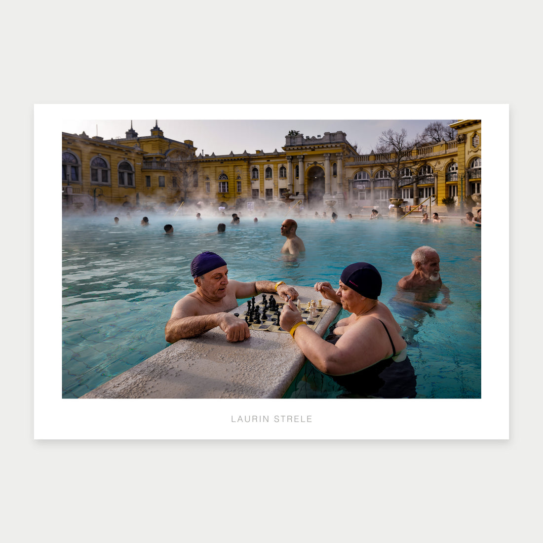 A1 photo poster of two bathers playing chess in a steaming outdoor pool, by Laurin Strele, with a white border and light-grey artist name.