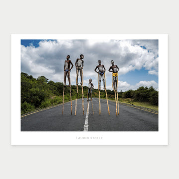 A1 photo poster of Children on Stilts, Ethiopia by Laurin Strele, shown with a white border and light-grey artist name.