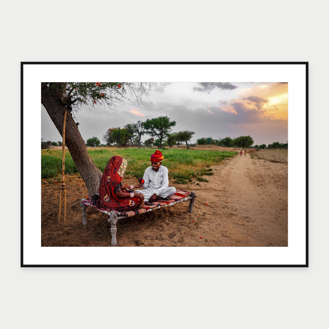 Black-framed display mockup of Family in Rajasthan by Laurin Strele; frame shown for illustration.