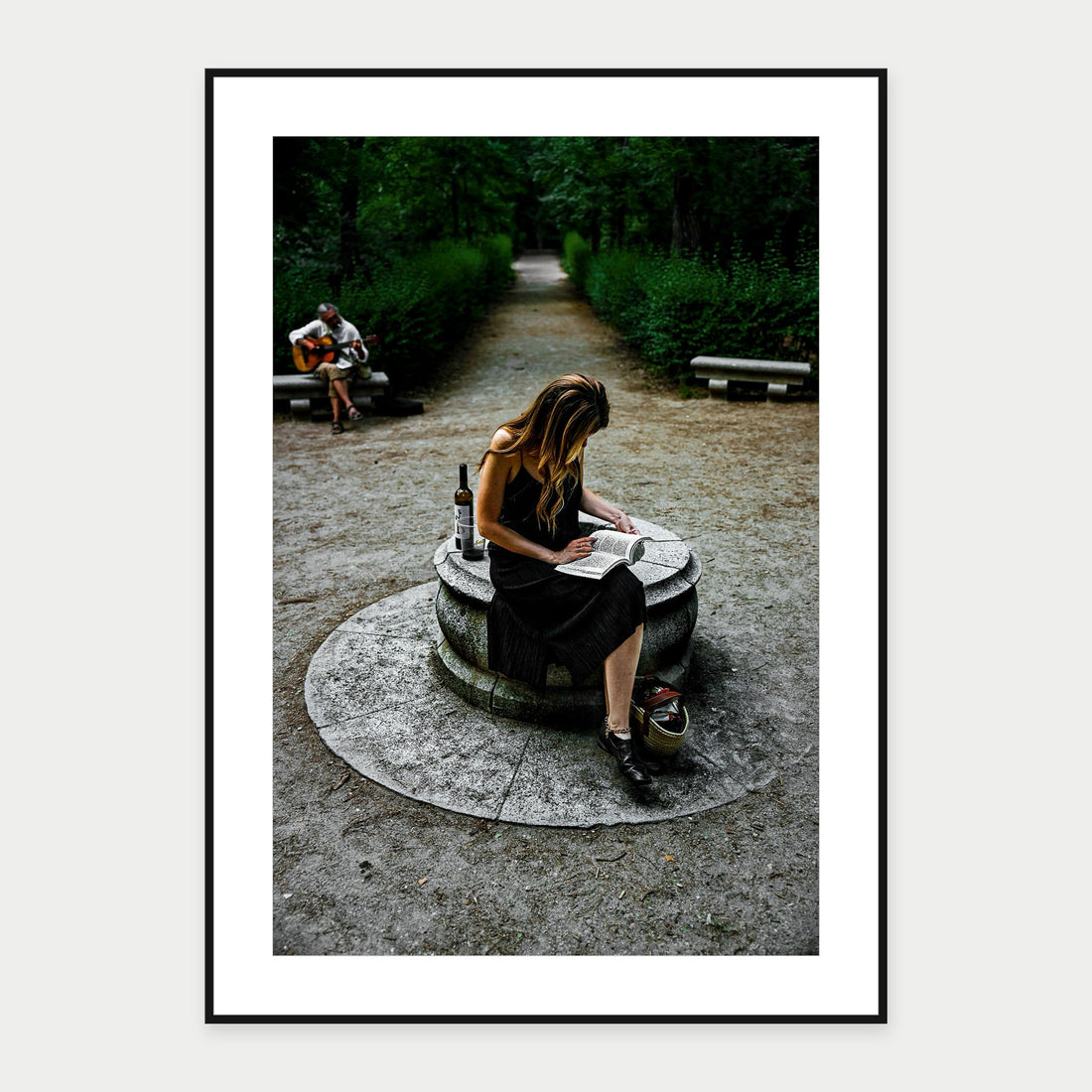 Black-framed display mockup of Reading in Retiro Park by Laurin Strele; frame shown for illustration.