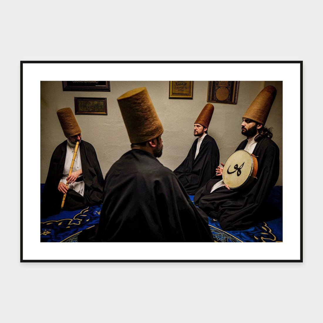 Black-framed display mockup of Sitting Sufis by Laurin Strele; frame shown for illustration.