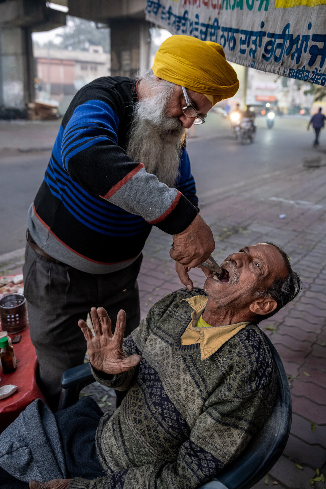 A1 poster of The Street Dentist in Amritsar, India, by Laurin Strele, shown with a white border and light-grey artist name.