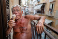 Antonio eats an ice cream on his balcony in Naples, Italy, with a Tutto Passa tattoo across his chest. Photograph by Laurin Strele.
