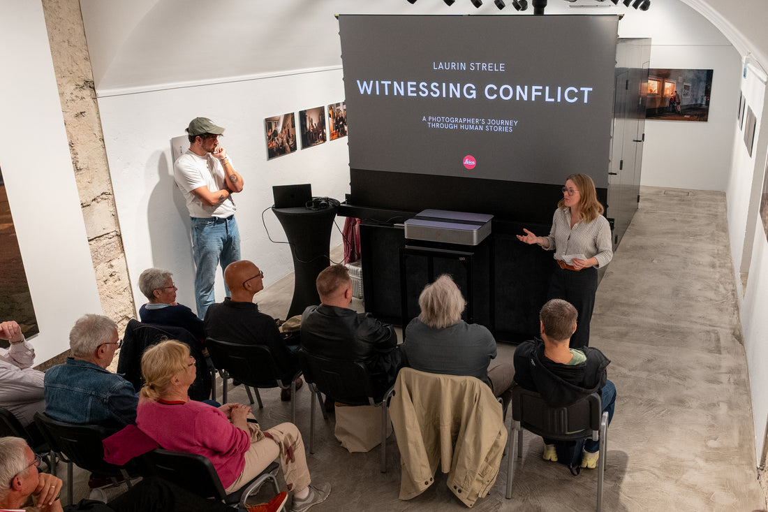 Laurin Strele and a speaker before an audience at a presentation of Witnessing Conflict.