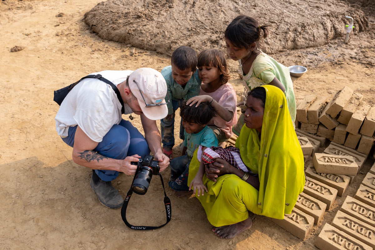 A photographer sharing camera images with a family during a workshop