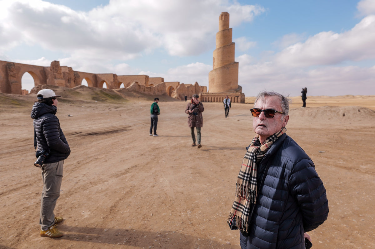 Workshop photographers beside brick arches and a spiral minaret.